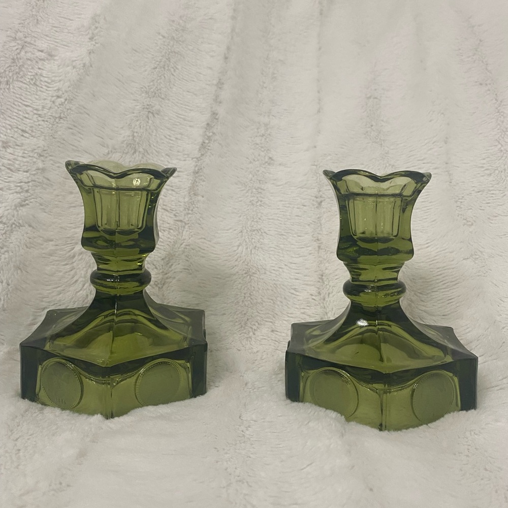 Two vintage Fistoria bell and coin olive green glass candle holders.